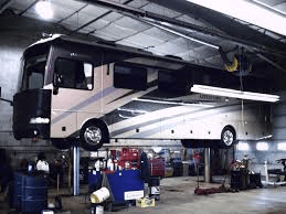 RV in repair shop on lift